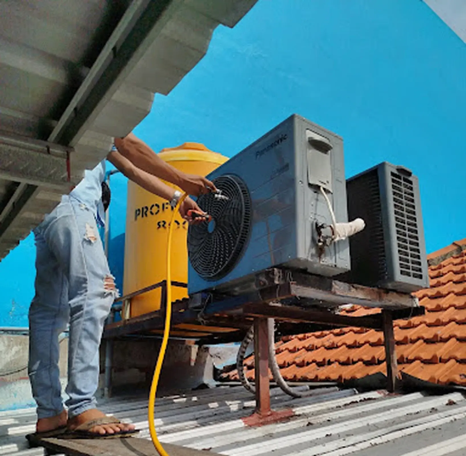 Professional AC technician working on a unit